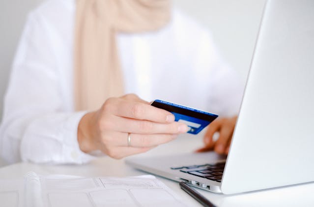 person making an online payment on laptop